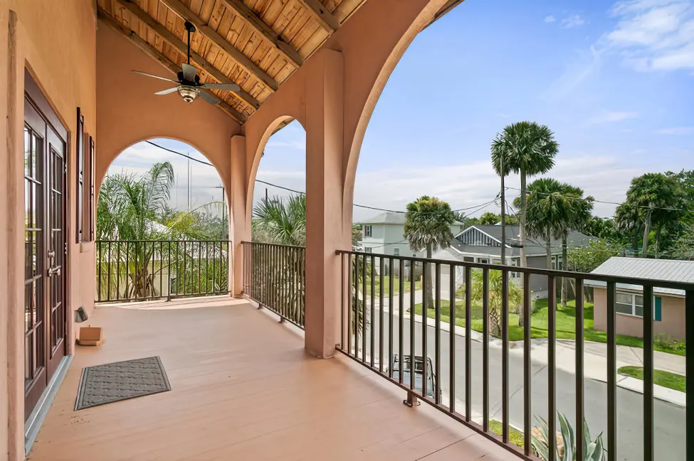 Upper floor balcony with a view that includes palm trees