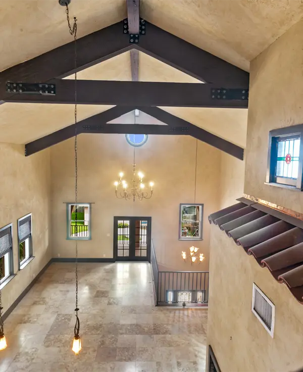 The interior features a high vaulted ceiling and marble floors