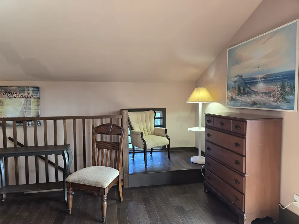 The "Nautical" bedroom has a sloped ceiling and safety rail around staircase